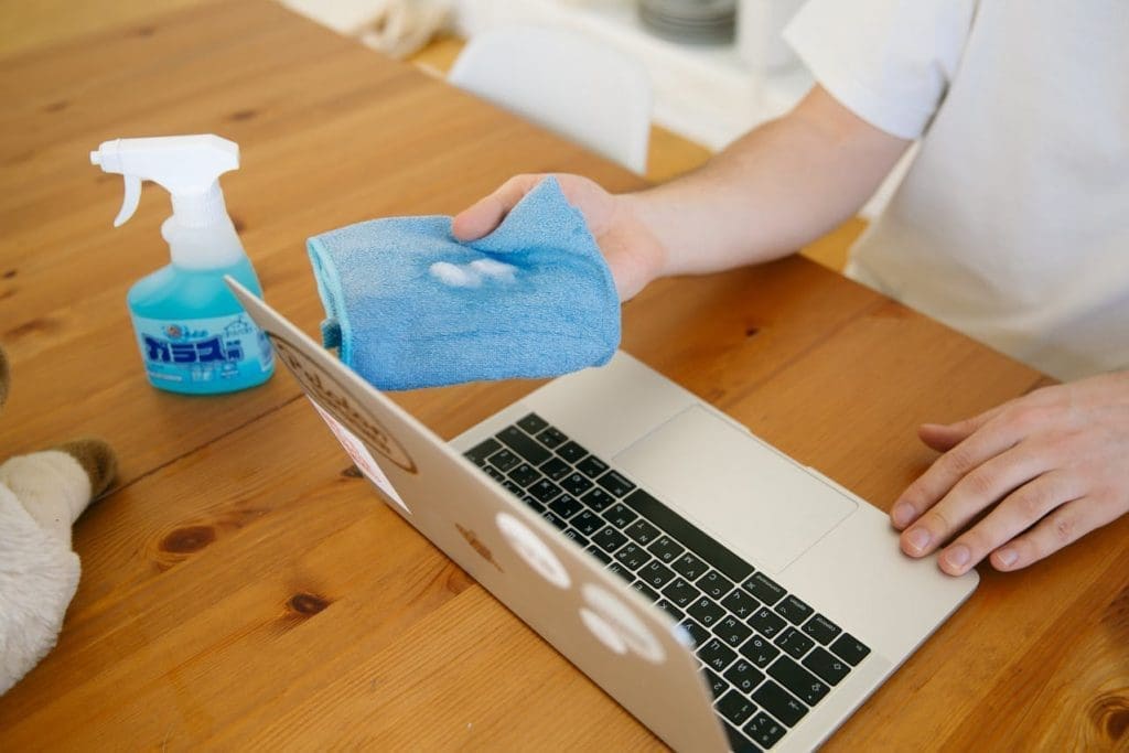 person cleaning computer